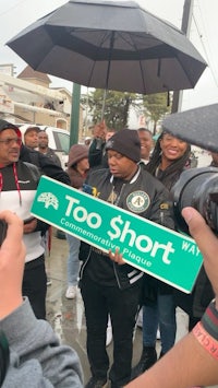 a group of people holding up a sign that says too short